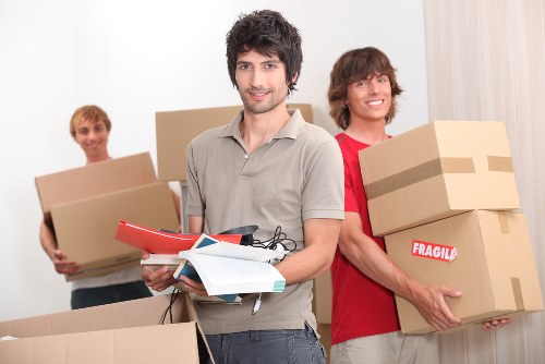 Professional movers handling household items with care