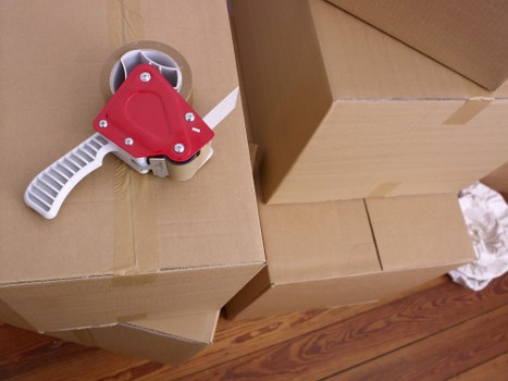Movers working together with safety equipment and care