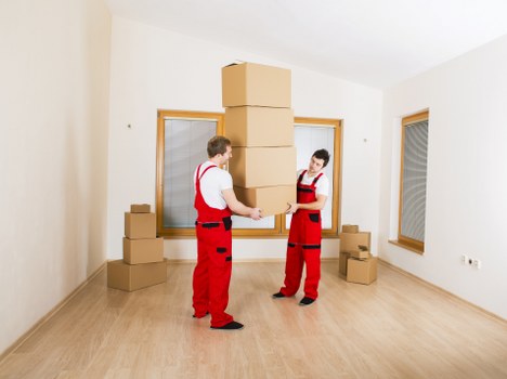 Professional movers carrying furniture during a Kennington relocation